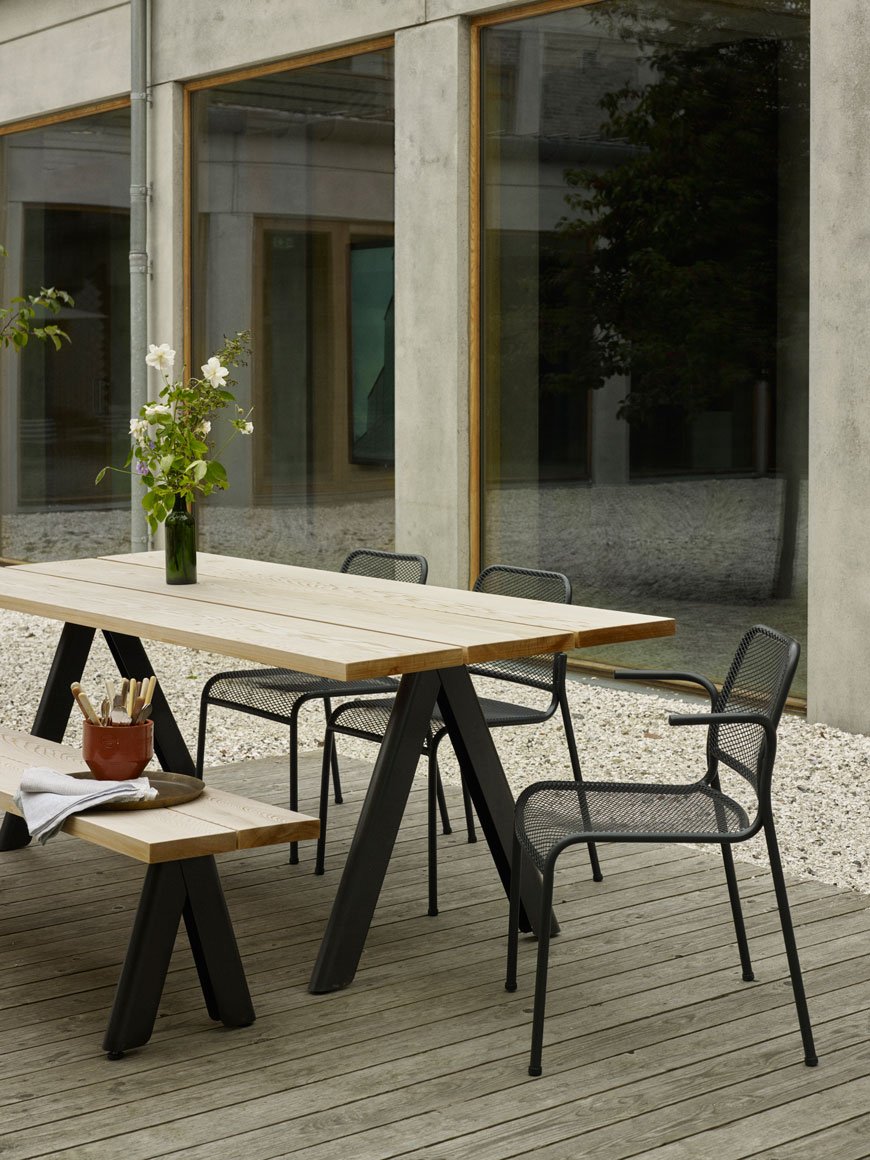 Minimalist outdoor furniture on a weathered desk from Skagerak.