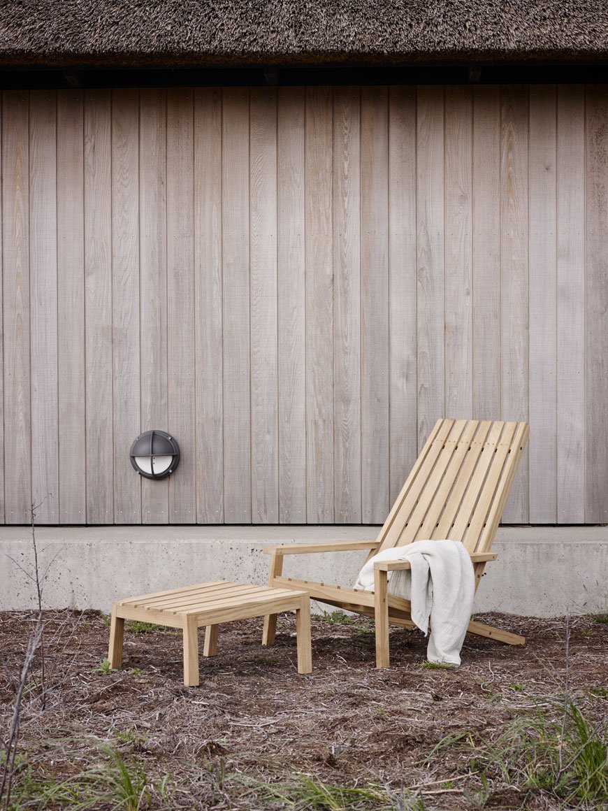 A slatted deck chair illustrates Modern Scandi outdoor furniture style. 