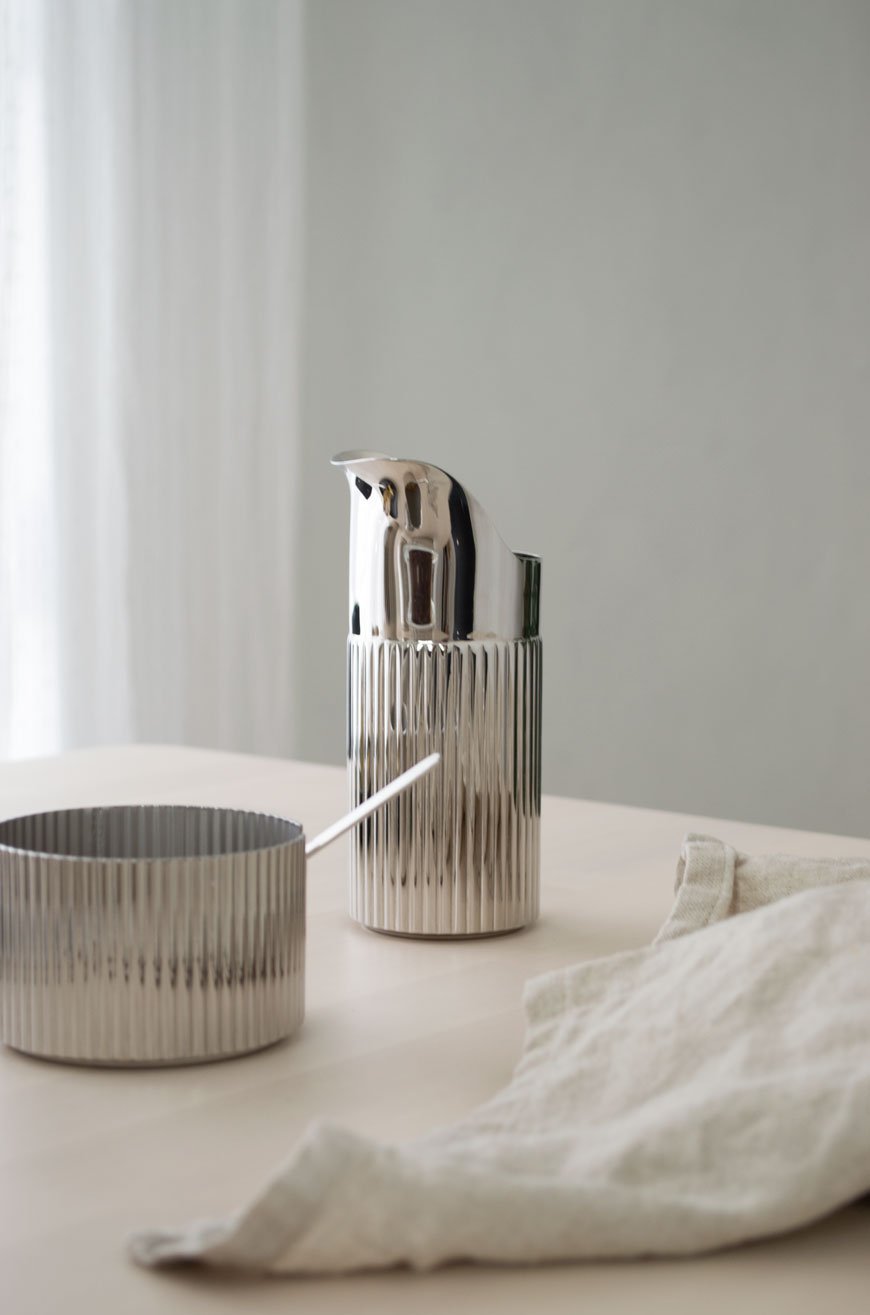 Ridged stainless steel milk jug and sugar pot, designed by Georg Jensen. 
