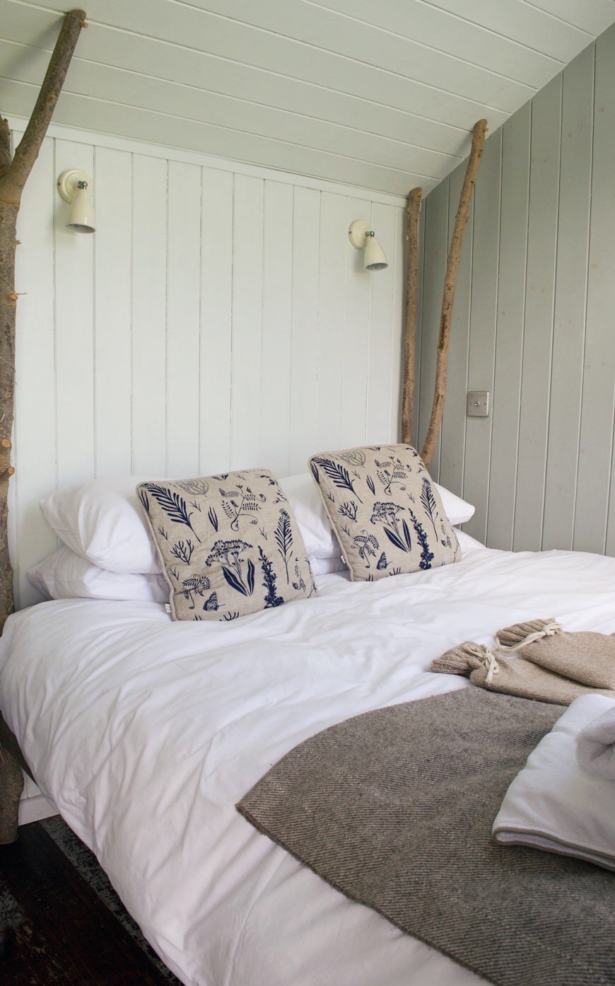 A plump and cozy kingsize ash four poster bed inside Vanellus at Elmley Nature Reserve.