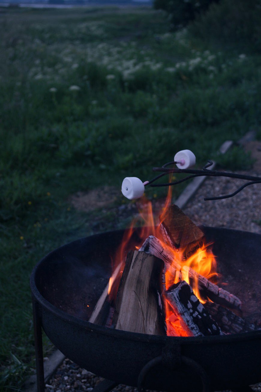 Toasting pink marshmallows over the iron firepit at sunset on Elmley Nature Reserve.