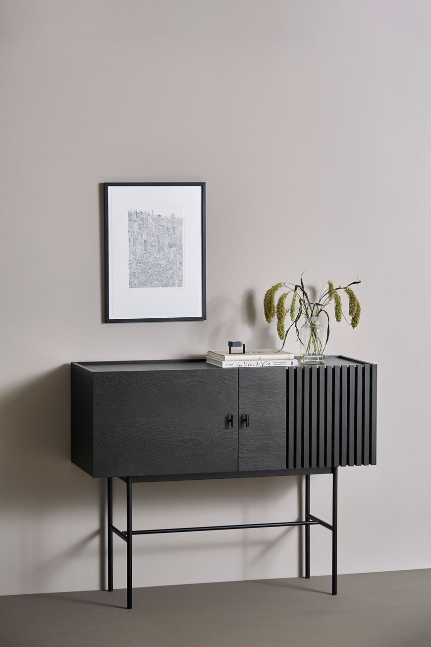 The one piece of furniture that works really hard in the dining room is a sideboard like this one in black oak, designed by Woud and available at Pepper Sq. 