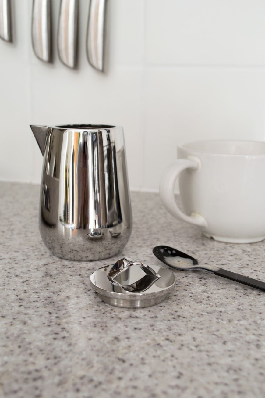 A sleek and minimal milk jug, from the new Georg Jensen Helix collection in a bright, minimal Scandi kitchen. 