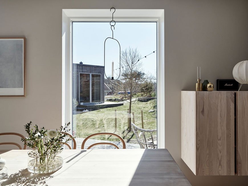Looking out onto Brännö island from the full length window inside this minimal, light filled Scandinavian dining room. 