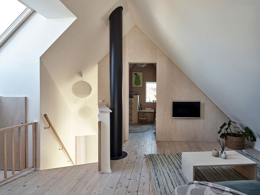 A cosy snug area at the top of the stairs between the two bedrooms in the eaves of this Sweden island home on Brännö island. 