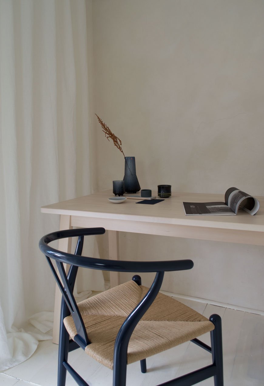 A side profile of the new limited edition 2020 Wishbone chair styled within a warm and minimal, Scandinavian style home work space. 
