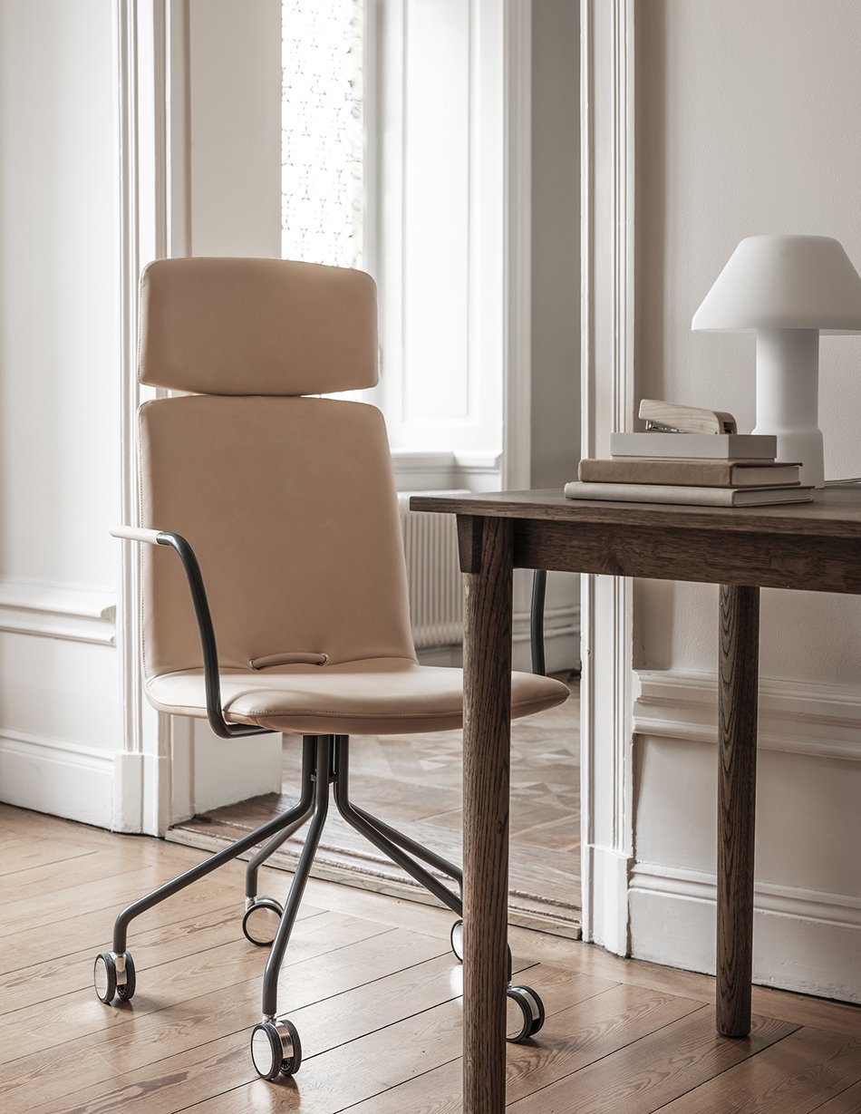 Light tan leather office chair in a minimal Nordic home workspace. 