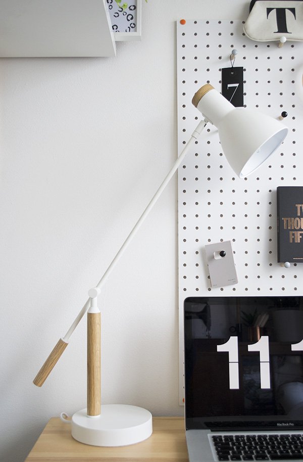 Minimal workspace featuring white PegBoard from Block and white 'Cohen' white desk lamp by MADE.COM. 