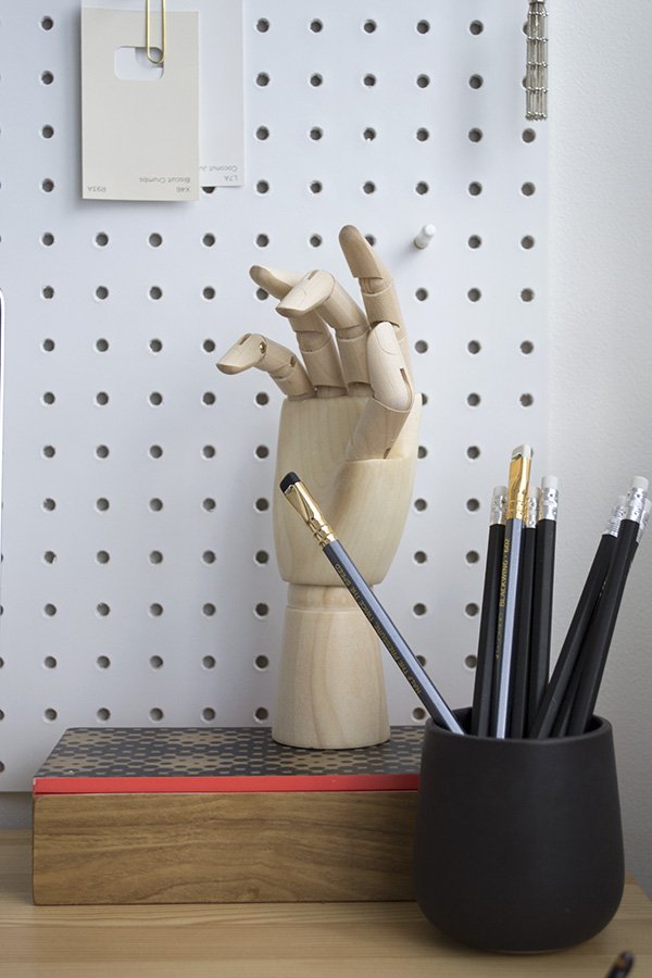 Minimal workspace featuring white Pegboard from Block and HAY wooden hand