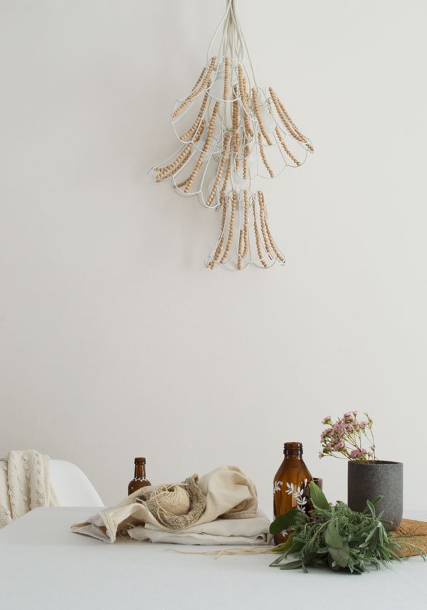 Out_There_Interiors_Wooden_Bead_Chandelier_String_Lighting_Winter01