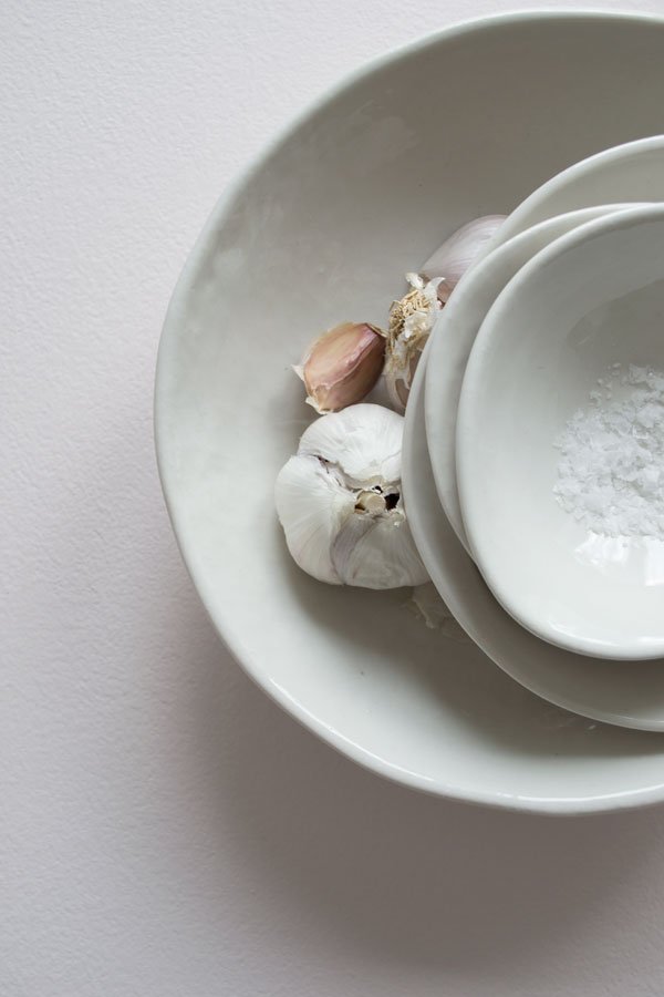 Still life, off-white ceramic wobble bowls and blushing garlic 