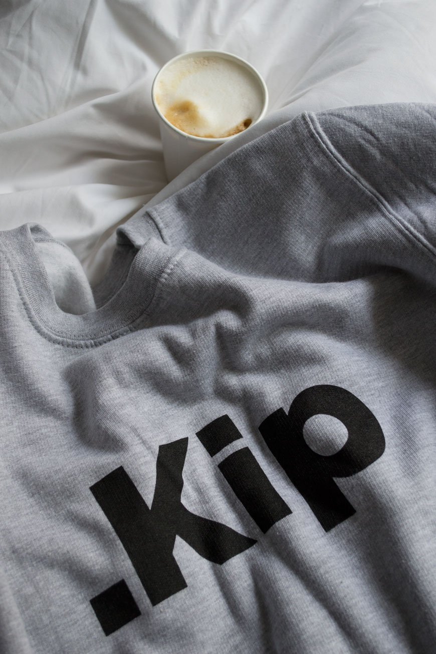 Custom grey sweatshirt with a takeout coffee cup from Kip hotel, London.