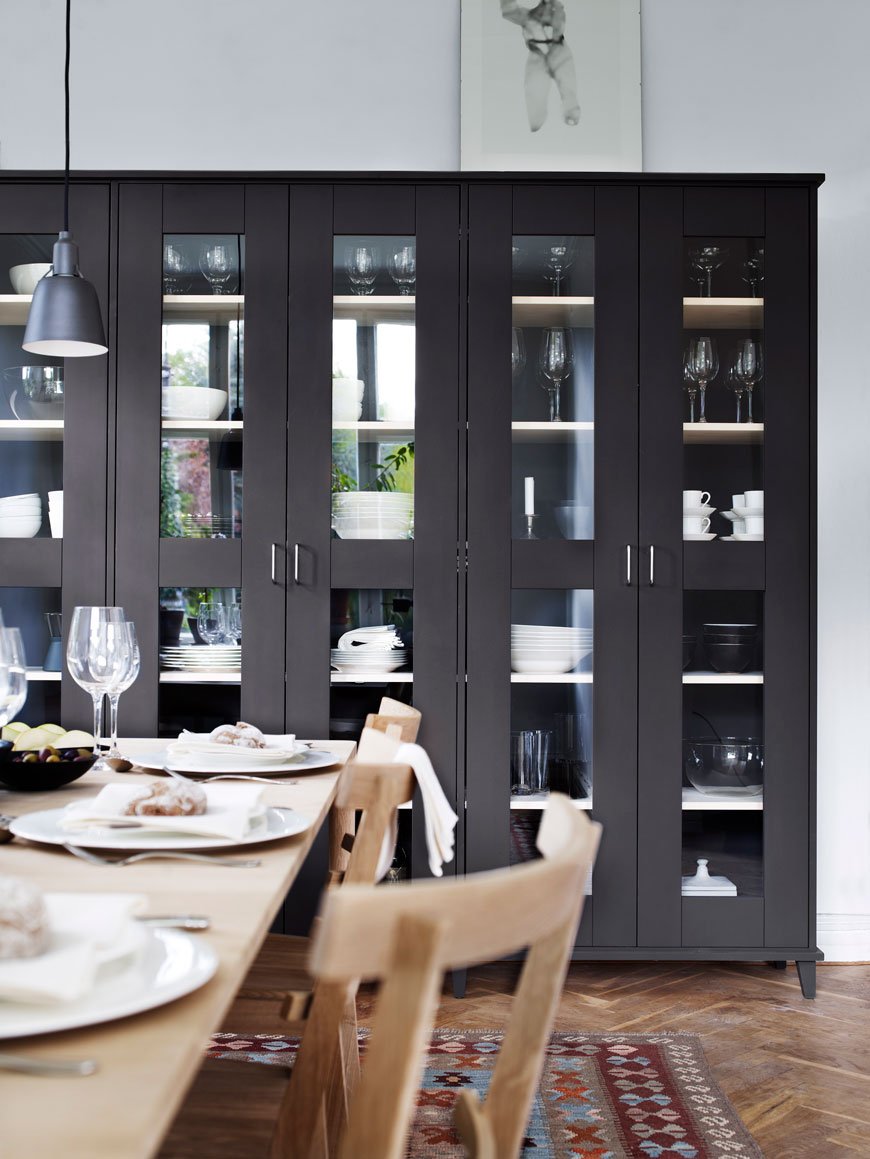 A wall of charcoal grey glass fronted storage cabinets designed by Norrgavel, sustainable Swedish furniture designers. 