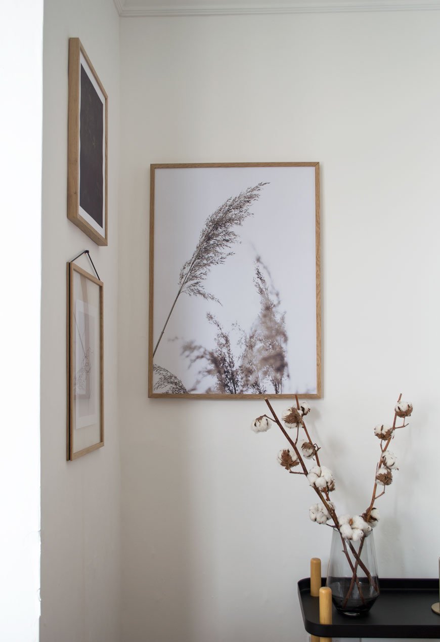 minimalist art prints, gallery wall, Scandinavian art, white interiors, white living room with Edwardian coving, cotton flowers in a clear vases on Normann Copenhagen trolley.