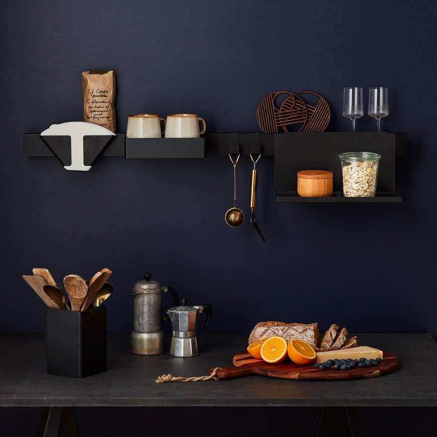 Black Flex rail wall mounted in a blue kitchen with coffee making utensils, designed by Nordic design brand Gejst.