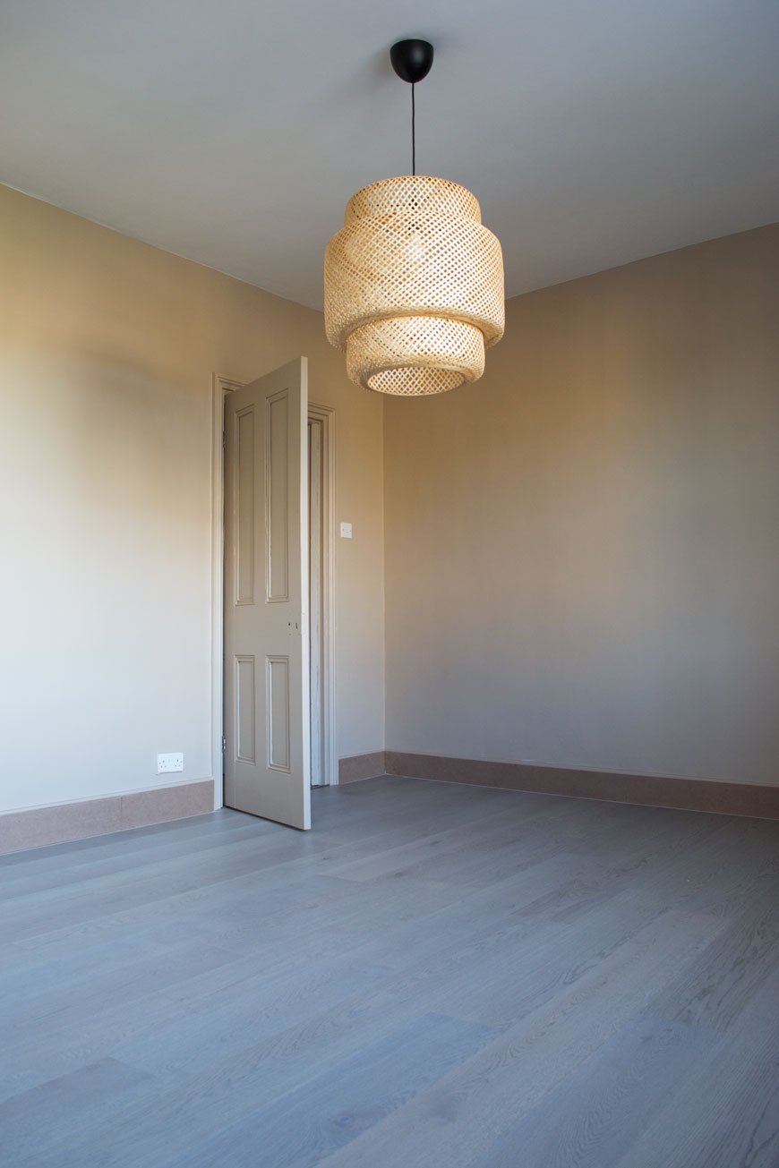 Our Havwoods engineered oak floor in Shadow Grey blends with our beige bedroom walls. 