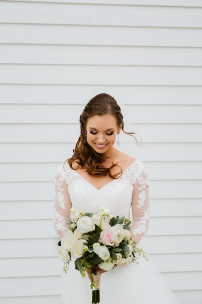 outer banks bride looking at her flowers on her wedding day