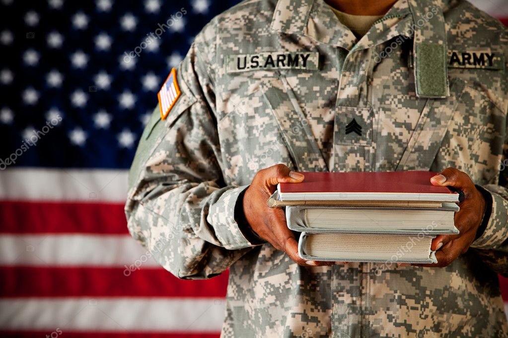 Military member holding a stack of books