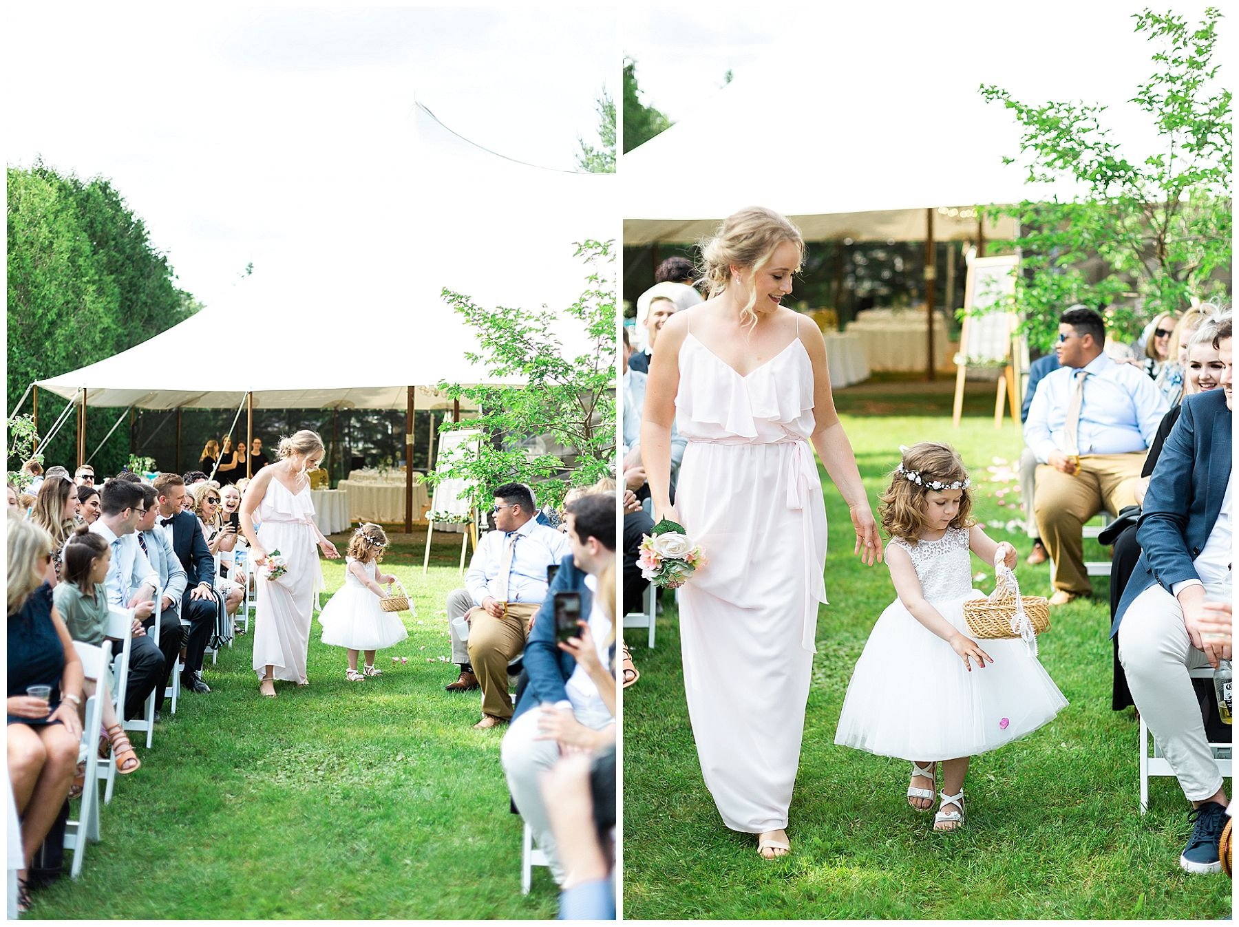 flower girl in white tulle walking down the aisle throwing rose petals