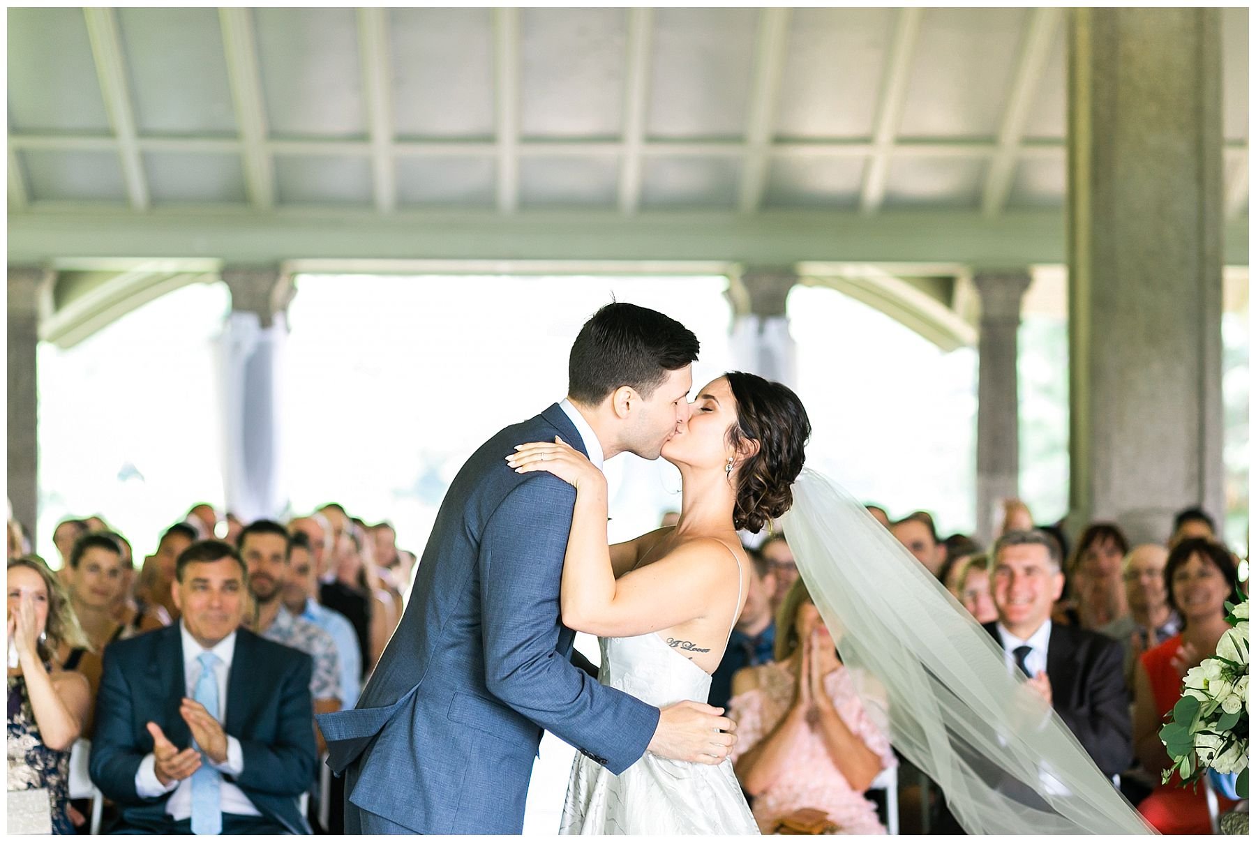 bride and groom first kiss at Rockcliffe park pavilion wedding ceremony