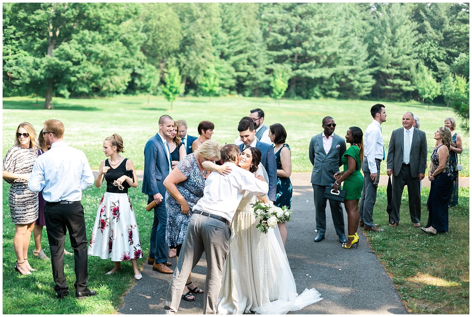Bride hugs guests at Rockcliffe park pavilion wedding 
