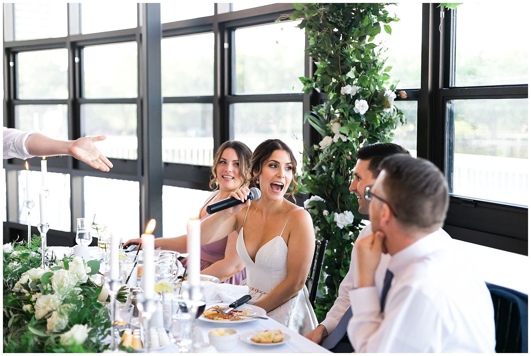 Bride sings into microphone at Lago bar grill