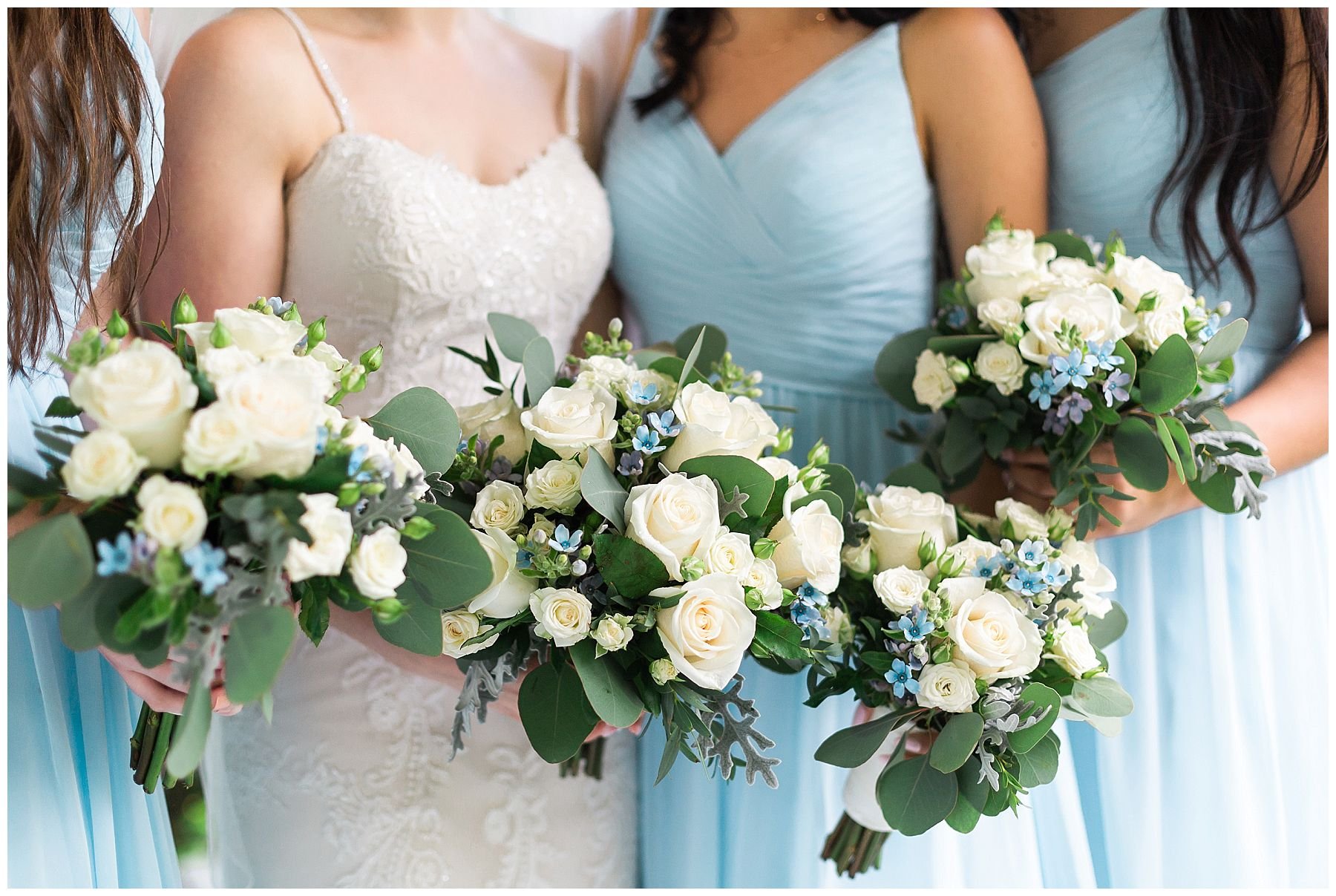 Bridesmaids in pastel blue dresses on a white porch