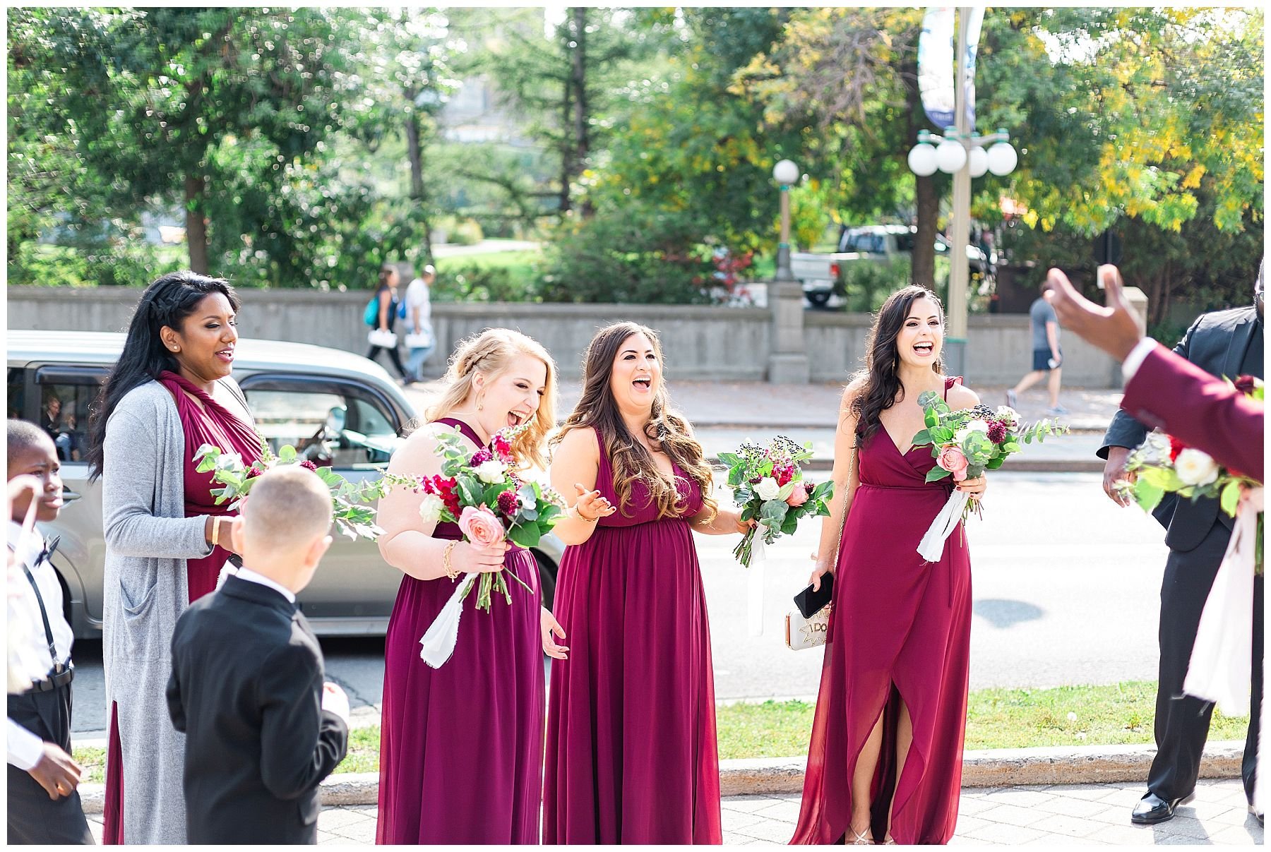 Burgundy bridal party cheering and laughing