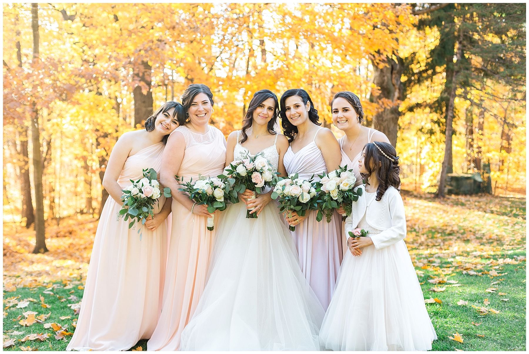 bridesmaids in blush dress in fall forest
