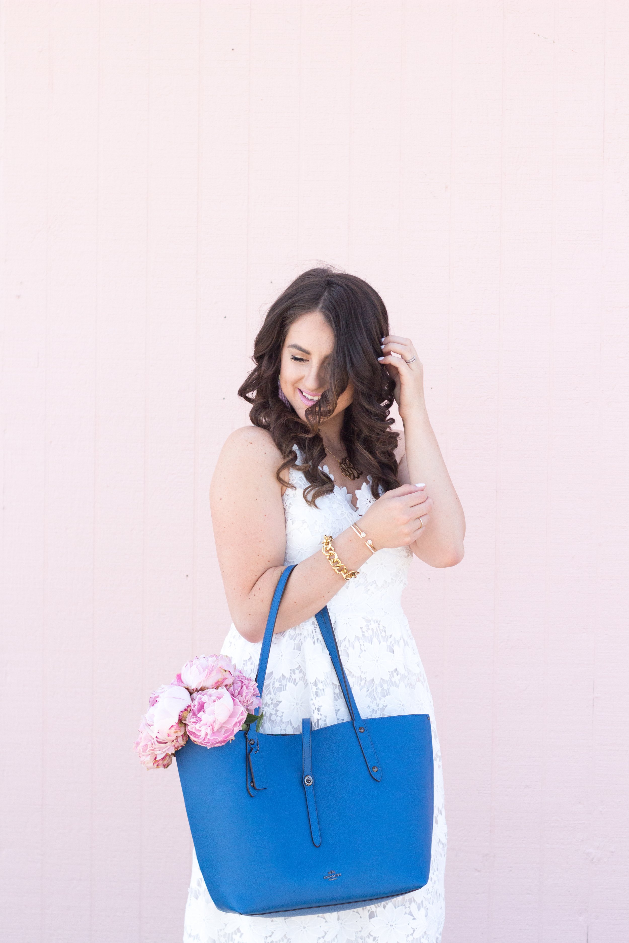Classic style for Summer in this white dress and blue coach bag for inspiration.