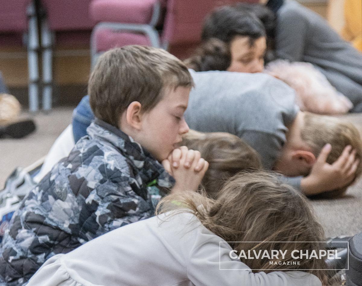 Kids on knees praying to God