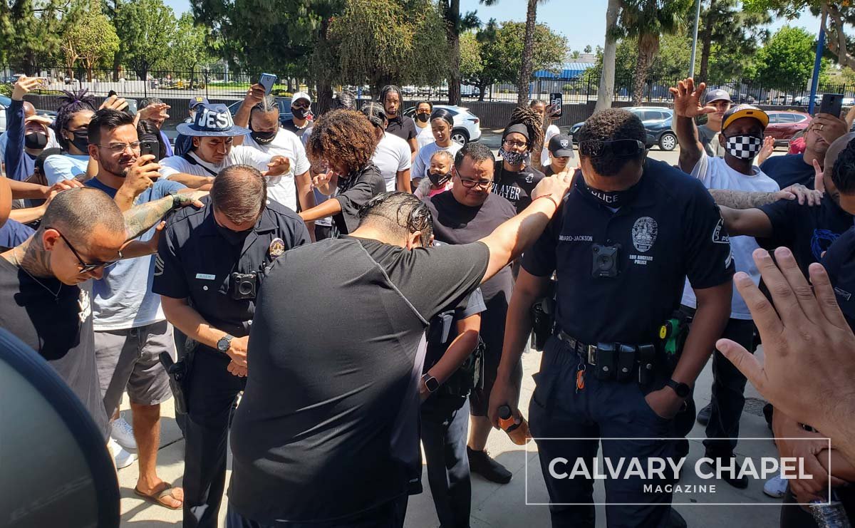 crowd prays for officer