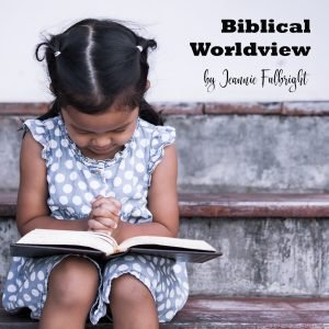 Little girl praying with open Bible
