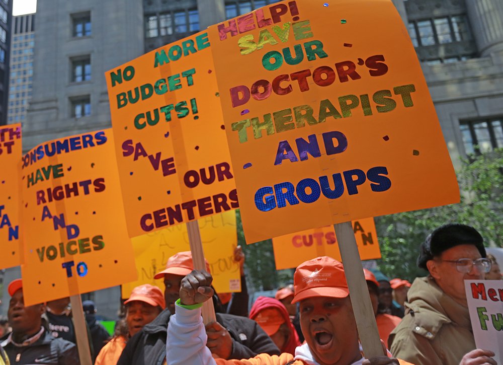 Cheryl Wallington (right) participates in a rally at the Thompson Center against budget cuts to mental health programs on May 13, 2014. 