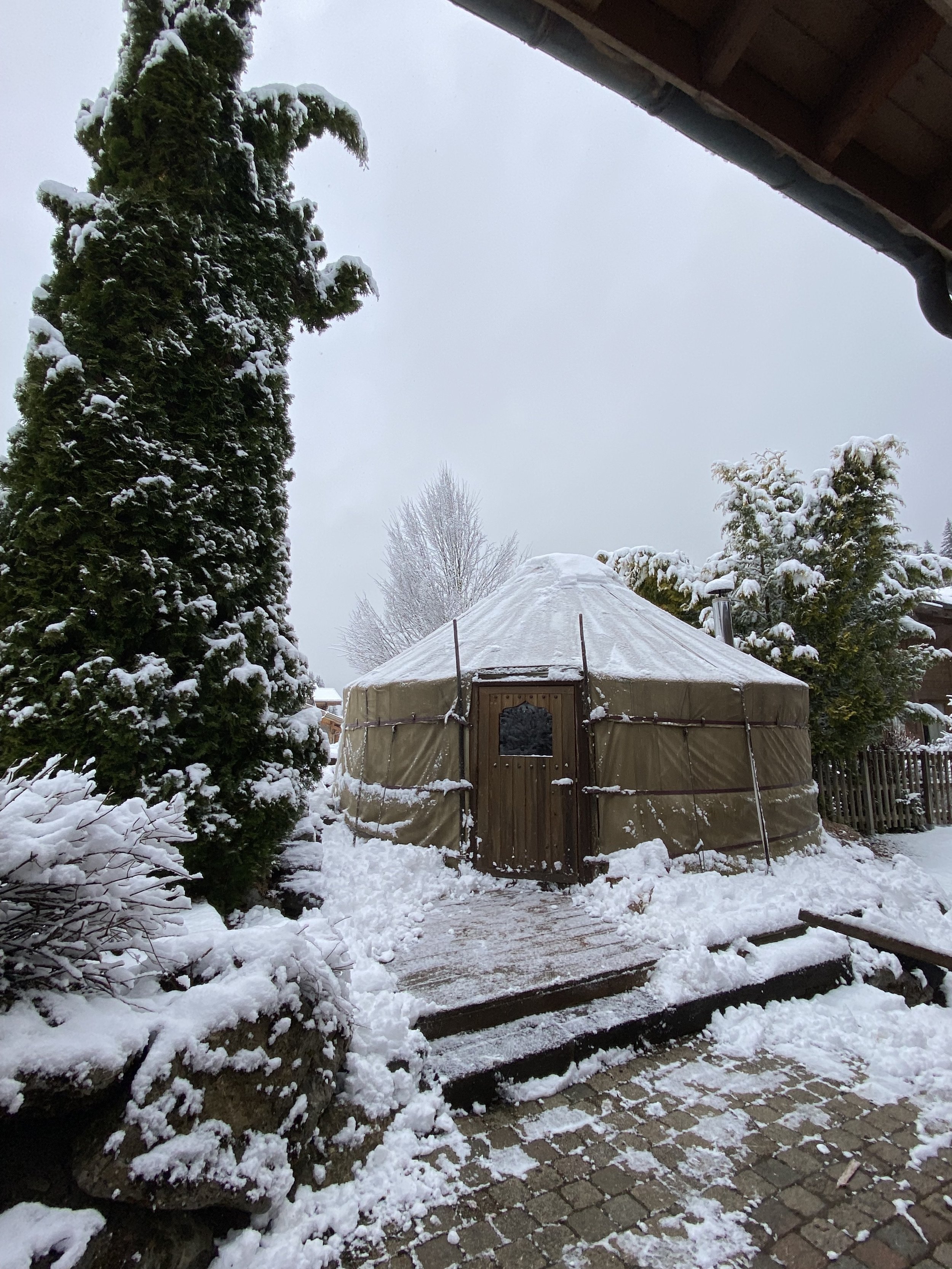 The massage hut at Chilly Powder. A wooden round yurt in the back patio area