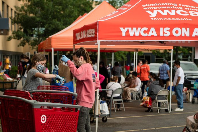 young volunteers pack a cart with supplies