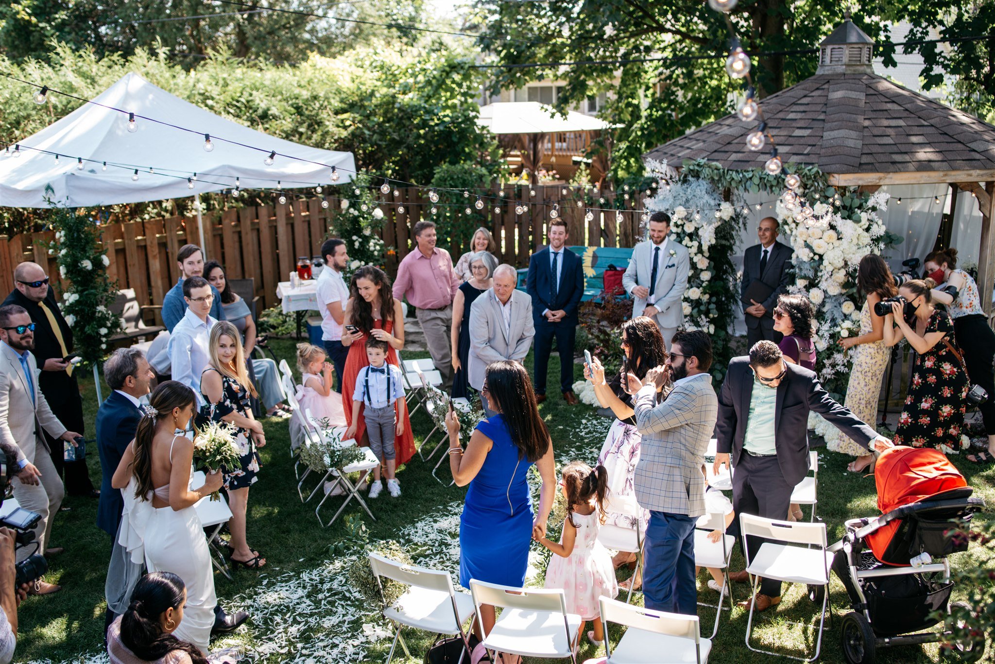 Family gathered at intimate backyard wedding in Montreal.