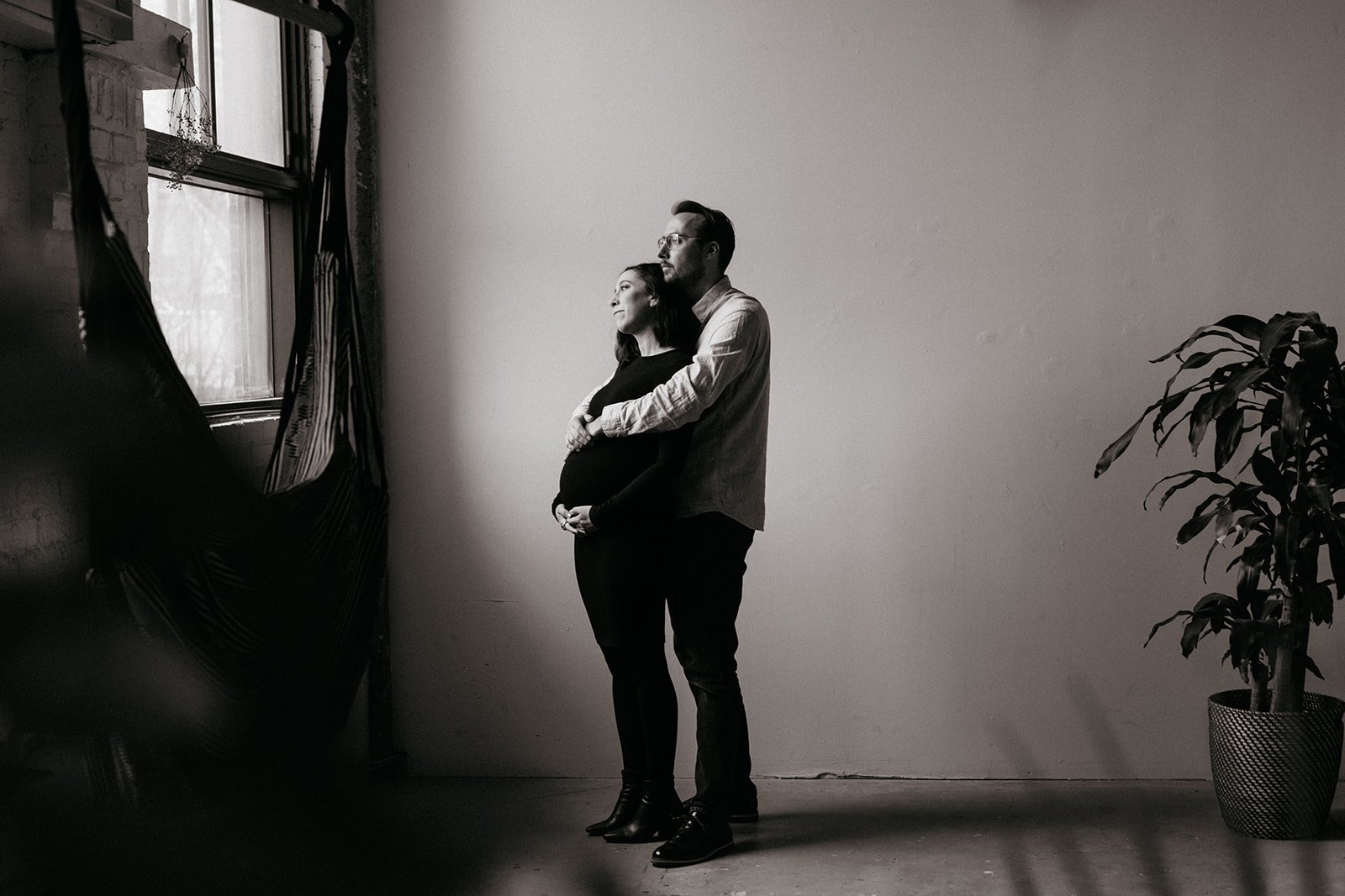 Montreal maternity session. Photographer takes photos of couple in-studio.