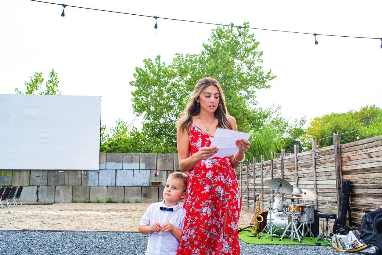 A sister makes a speech during toasts. Far Rockaway, NY. Shot by Angela Cappetta NYC Wedding photographer with a Nikon DSLR.