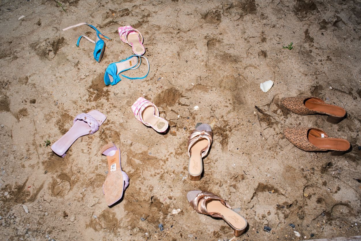 Shoes in the sand at a wedding in Far Rockaway, NY. Shot by Angela Cappetta NYC Wedding photographer with a Nikon DSLR.