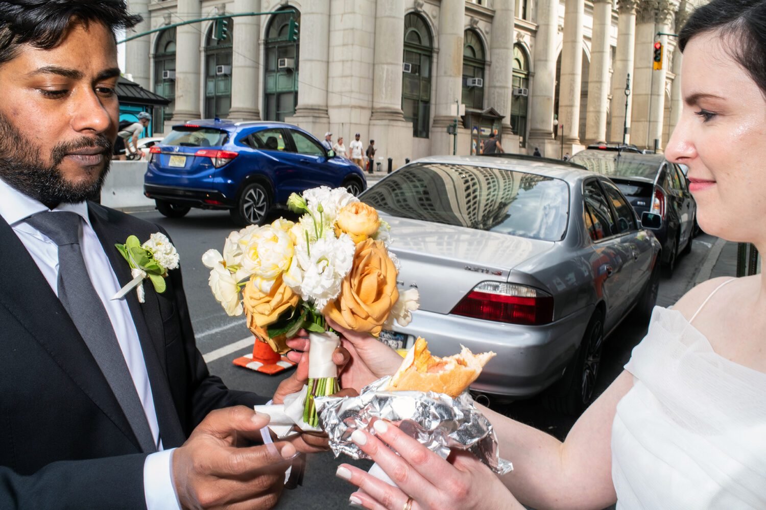 Sharing a hot dog. NYC Bangledesh wedding NYC City Hall shot by documentary style wedding photographer Angela Cappetta.