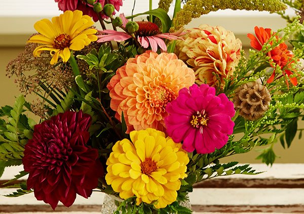Dahlia and Zinnia flowers are accented with different garden flowers.