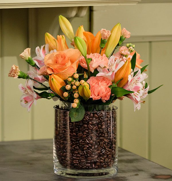 A Vase in a Vase filled with Coffee Beans- with Flowers placed gently inside... get it! 