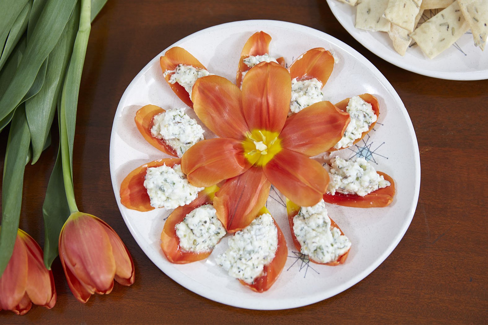 Flower Inspired Recipes or Flower Cocktails are included each week- on “J Schwanke’s Life in Bloom”, featured here is Herb Infused Goat Cheese served on Organic Tulip Petals.