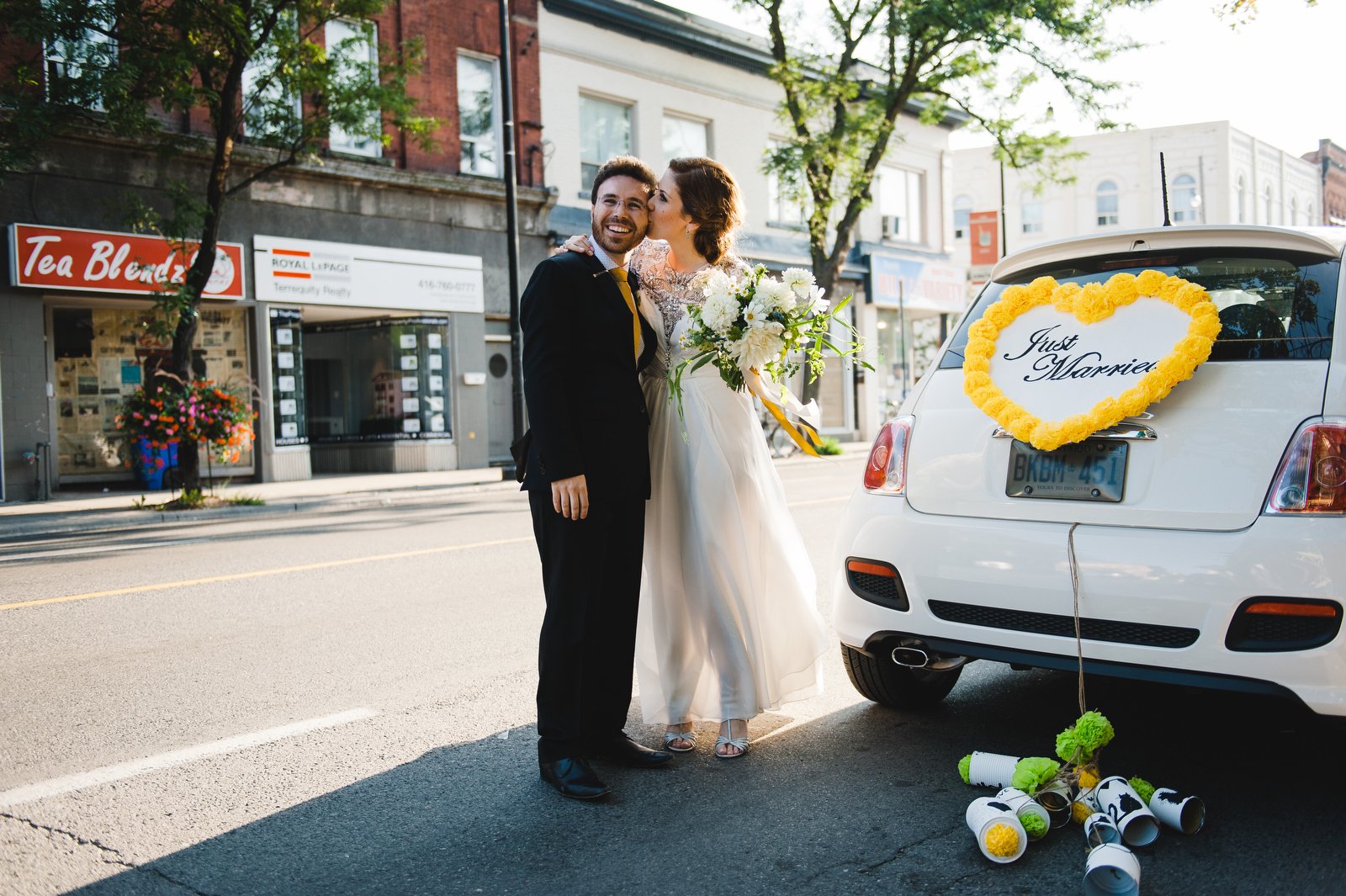 anna and daniel and their just married sign after their indie ale house wedding in the junction toronto