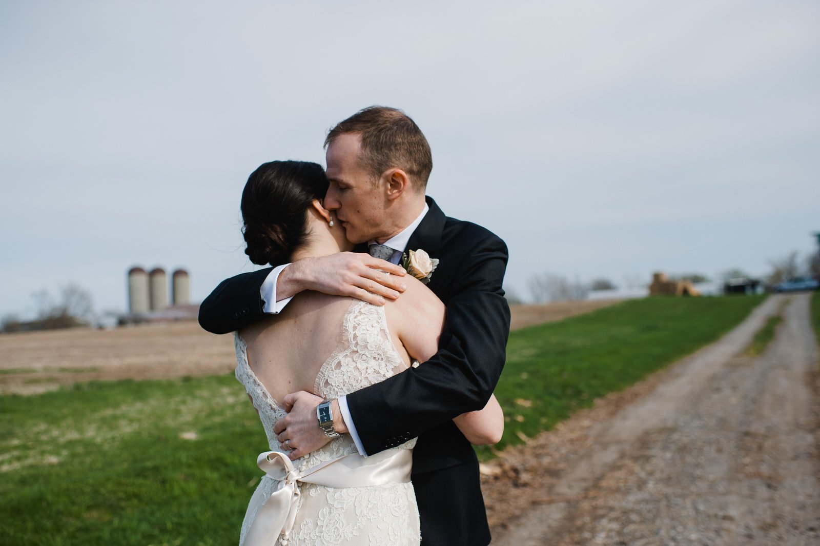 allison and matthew embrace | ontario farm wedding | fields on west lake