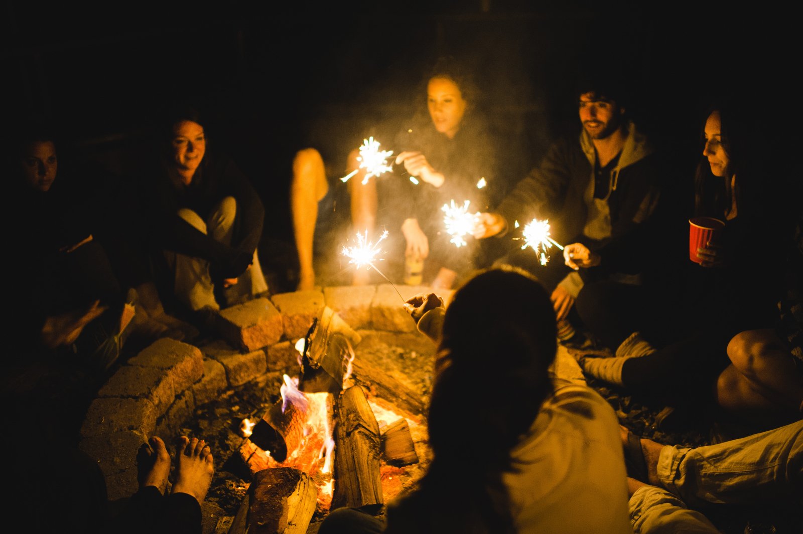 campfire with sparklers | ontario summer camp wedding | muskoka wedding photographers jenn and dave stark