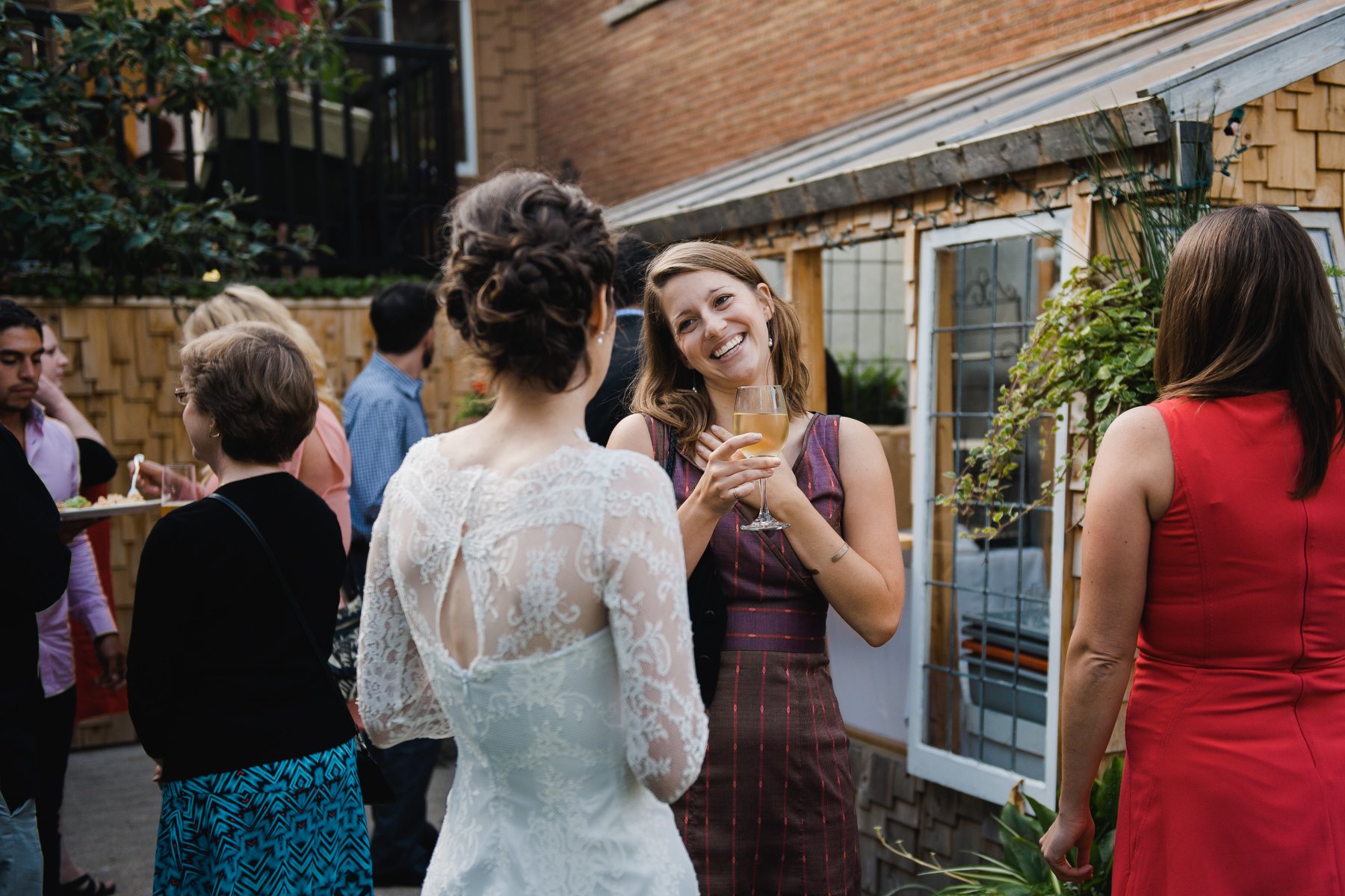 chatting with guests at her backyard wedding