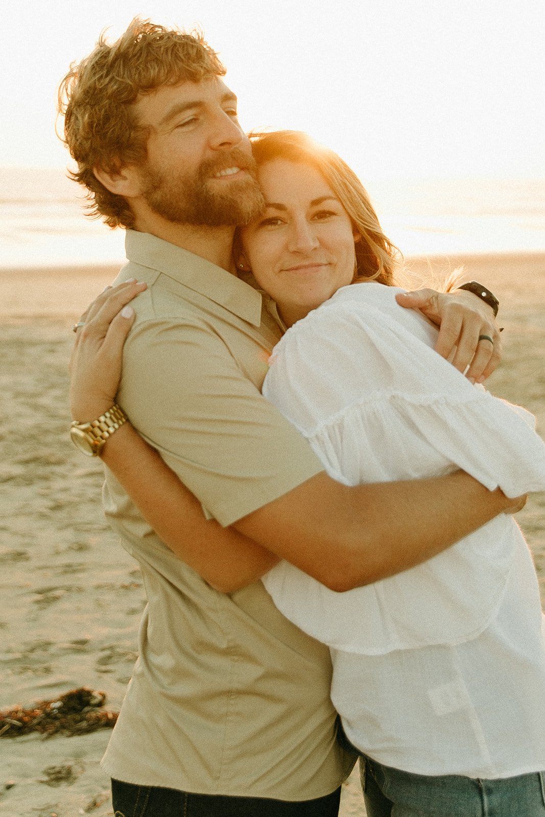 Couple hugging and smiling on the beach