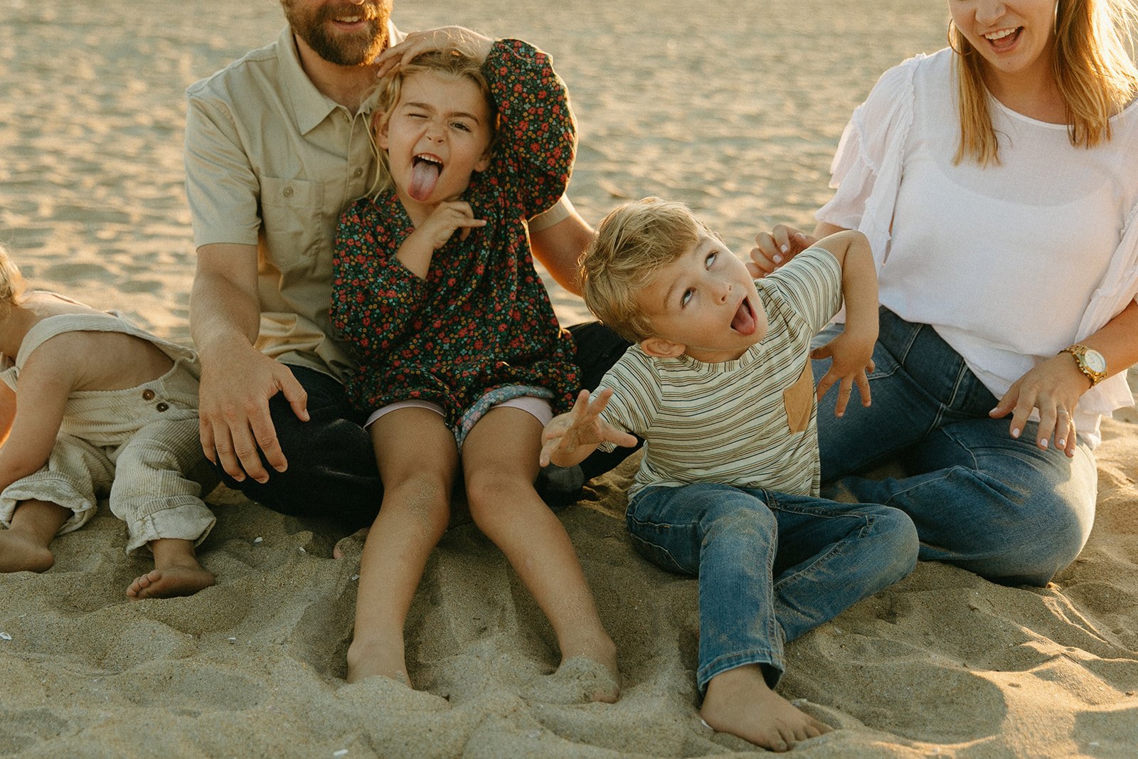 Parents and kids making silly faces on the beach during their family shoot